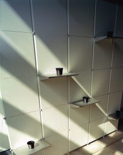 Leitner wall of modular panels with shelves